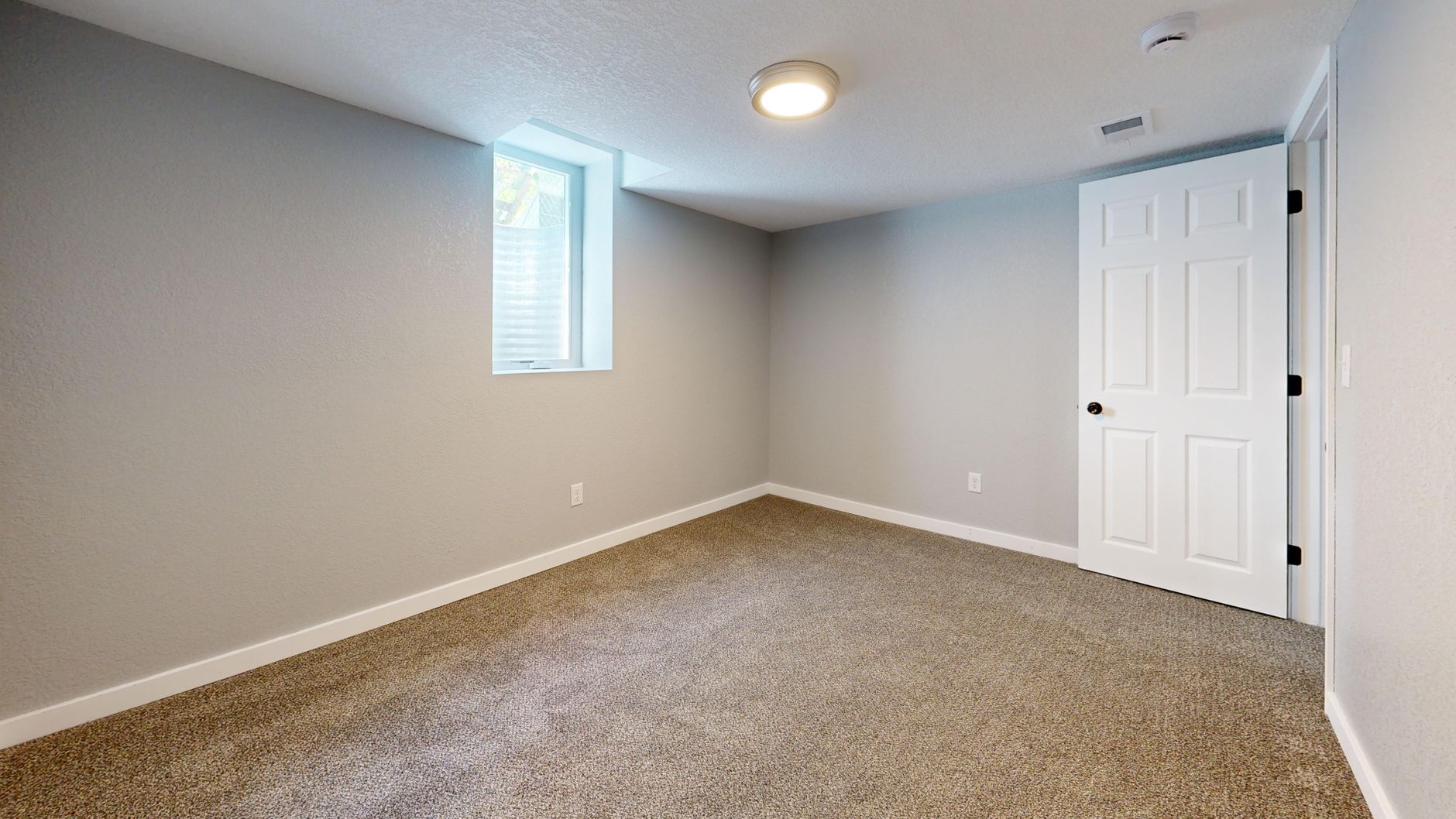 Neutral wall-to-wall carpet in a residential bedroom