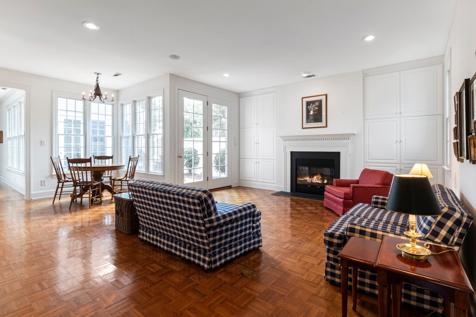 Hardwood flooring in a living room with a fireplace