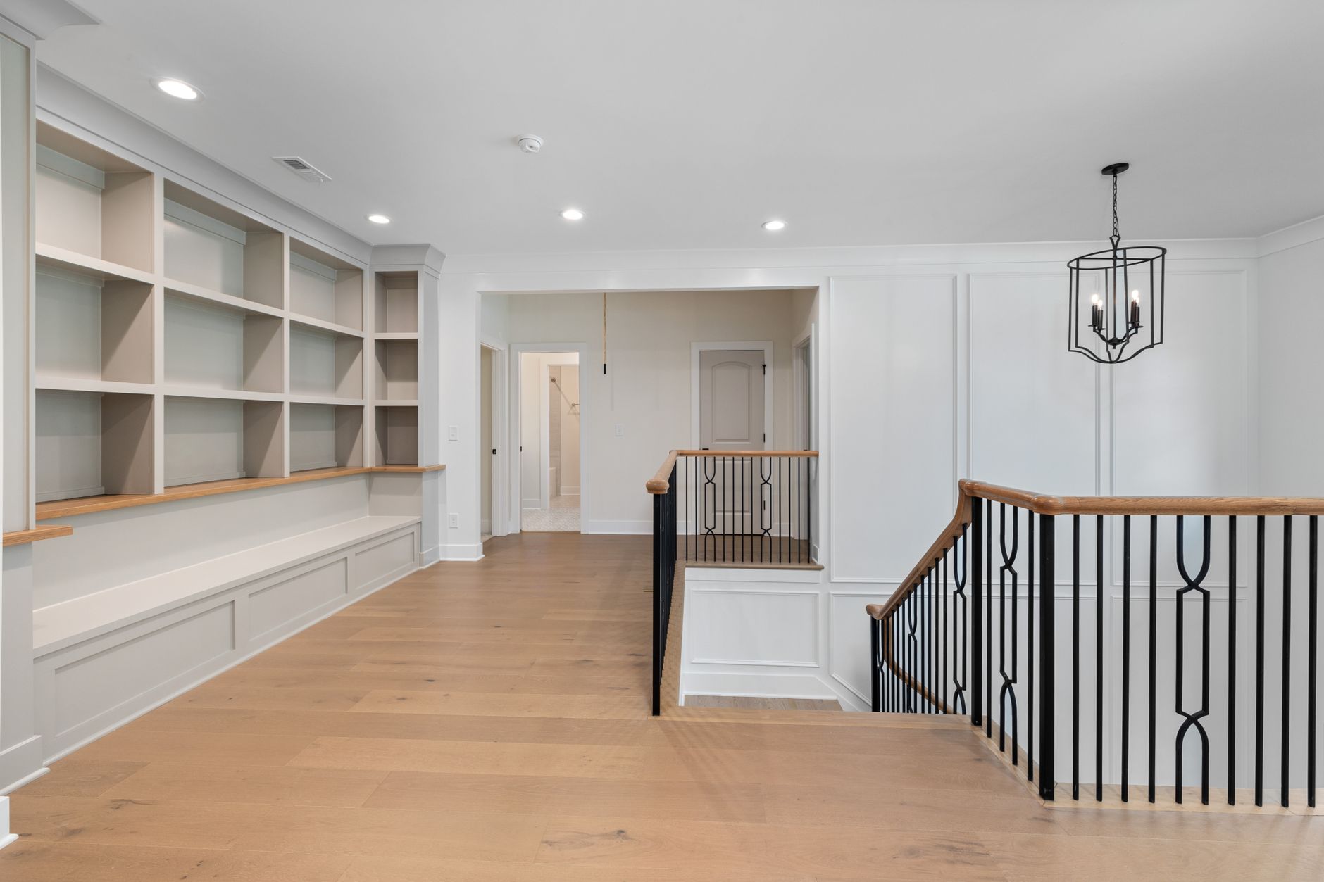Wood flooring in an entry foyer beside a staircase