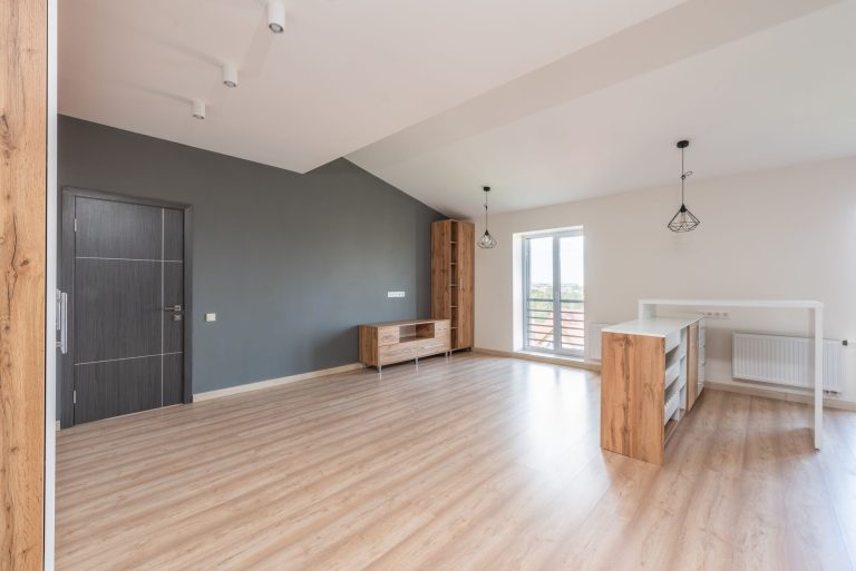 Luxury vinyl plank flooring in a modern living room with a grey accent wall