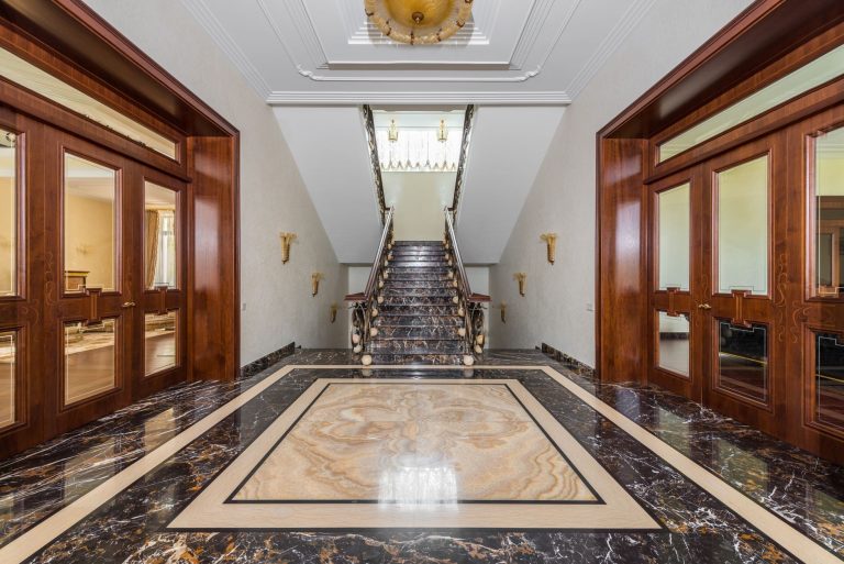 Polished marble stone flooring in a formal entry hall