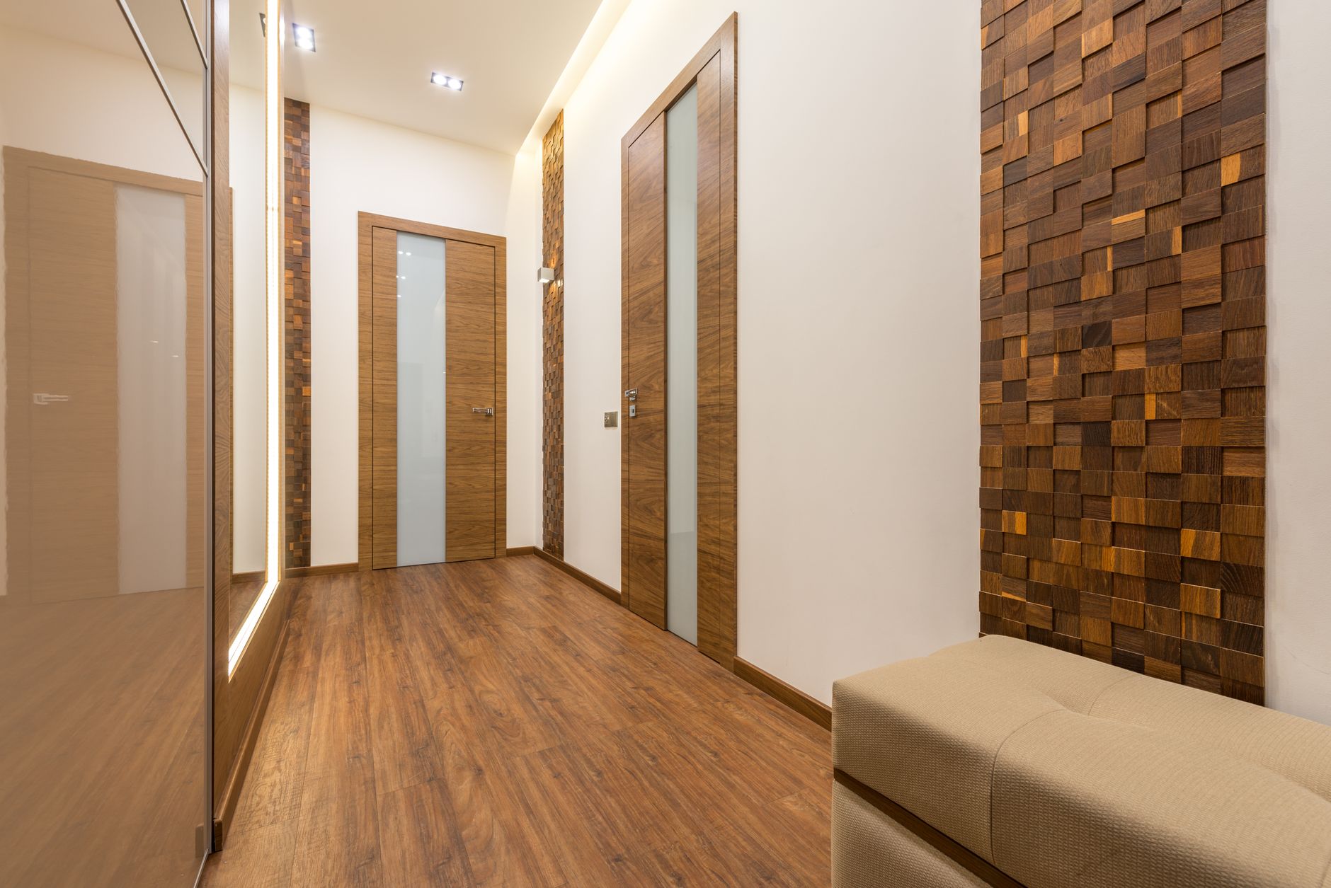 Parquet wood flooring running down a residential hallway